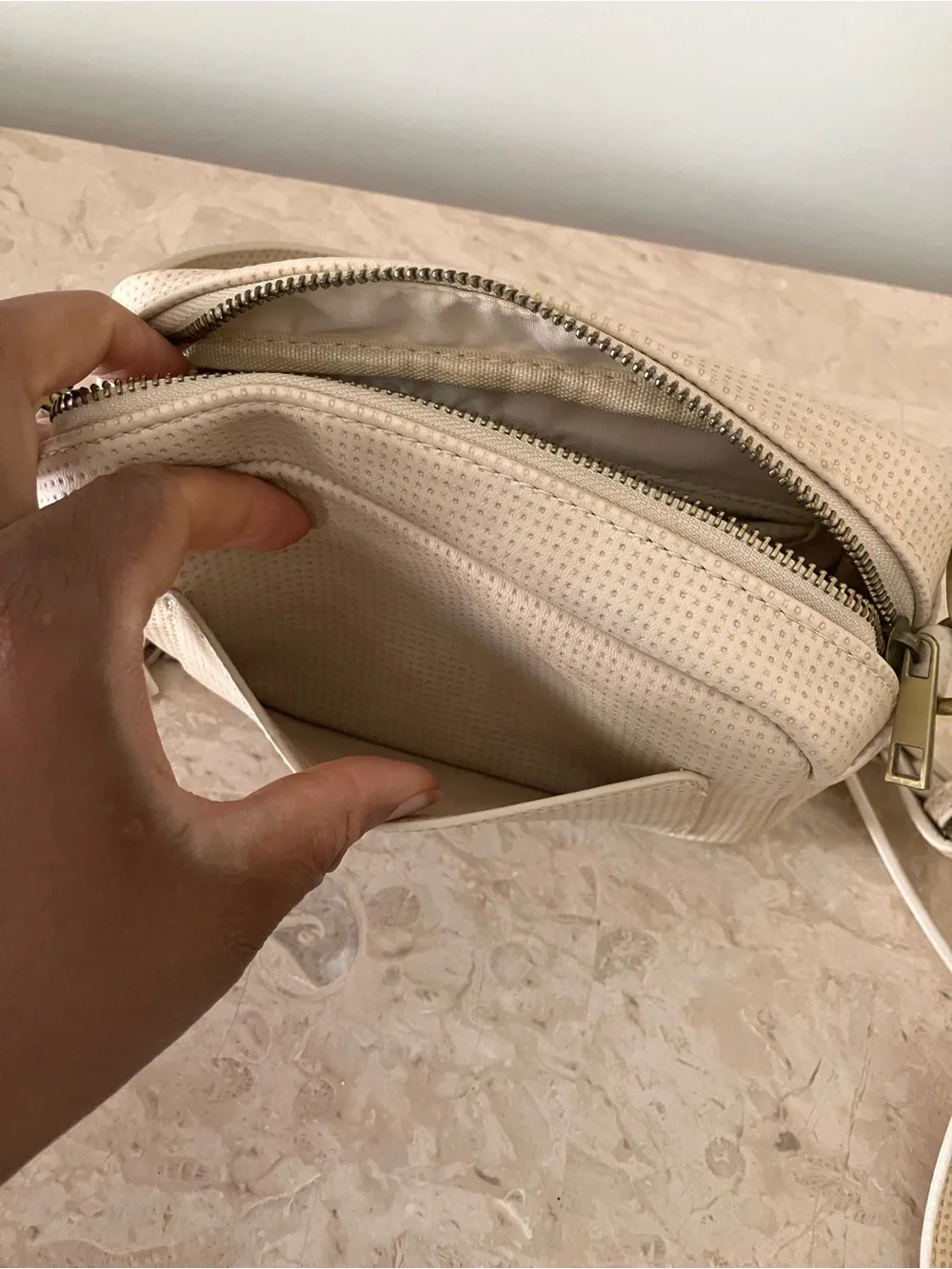 Anthropologie Cream Perforated Crossbody Camera Bag with Tassel